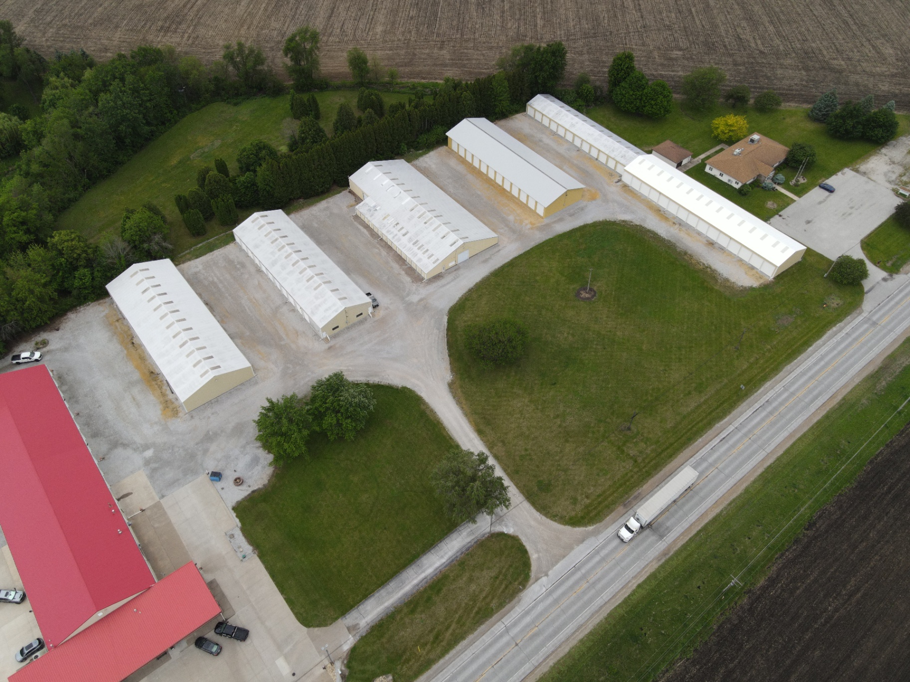 Aerial view of the Reid's Storage site with five storage buildings and wide gravel drive aisles